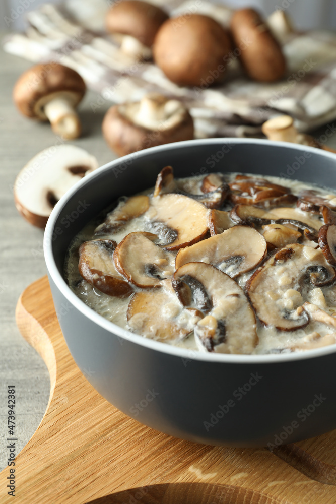 Concept of tasty food with mushroom sauce on gray wooden background Concept of tasty food with mushroom sauce on gray wooden background
