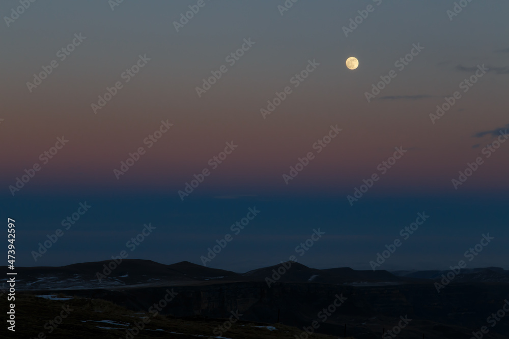 The moon in the setting cloudy winter sky The moon in the setting cloudy winter sky