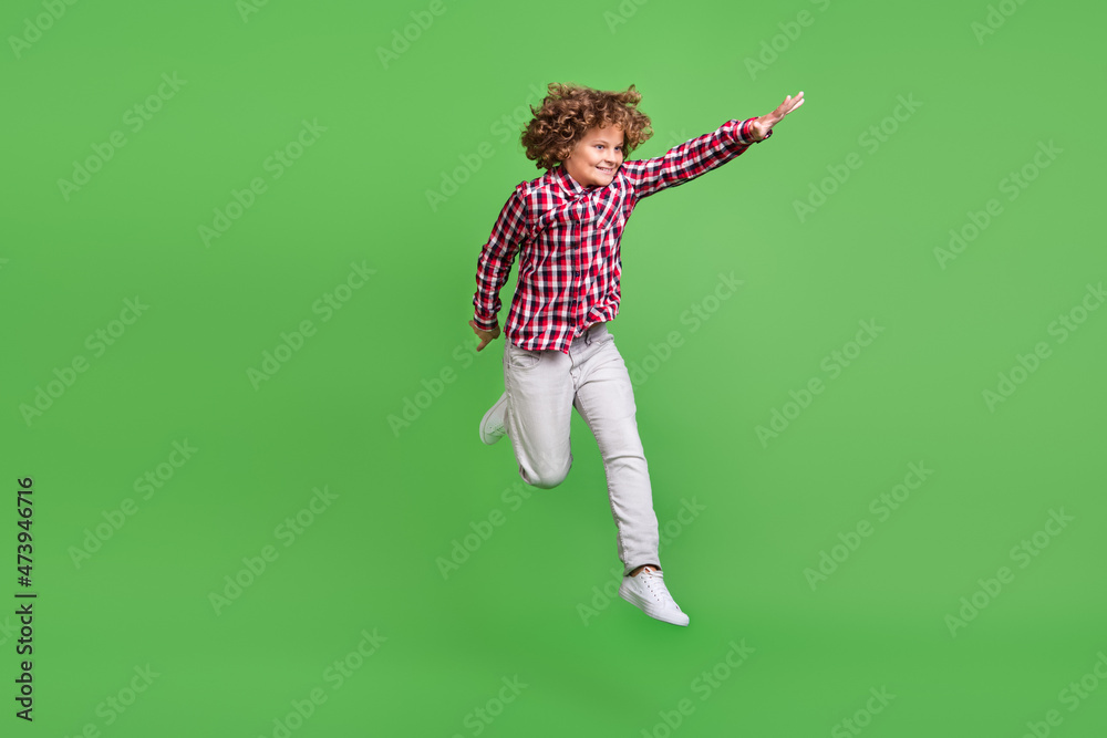 Full length body size view of handsome motivated cheerful guy jumping striving isolated over shine green color background
