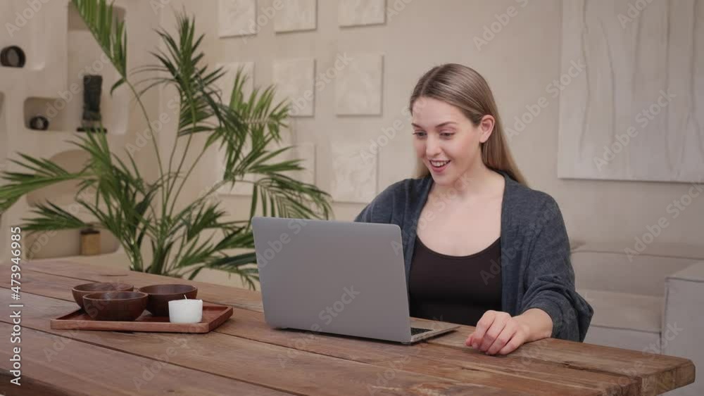 Young caucasian woman happy, joyful work laptop at home wooden warm apartment Young caucasian woman happy, joyful work laptop at home wooden warm apartment