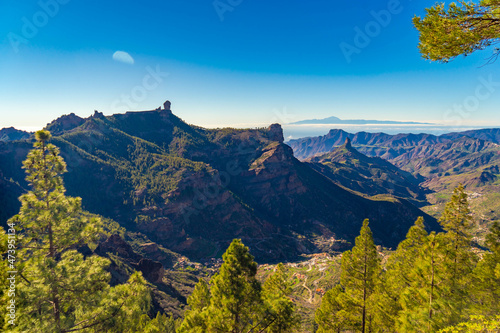 High summit landscapes of the Canary Islands with green vegetation after the rains with afternoon light, beautiful colors with the Roque Nublo, the Bentayga and the Teide in the beautiful background