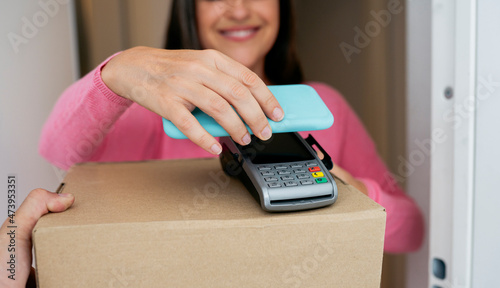 Woman paying through mobile phone