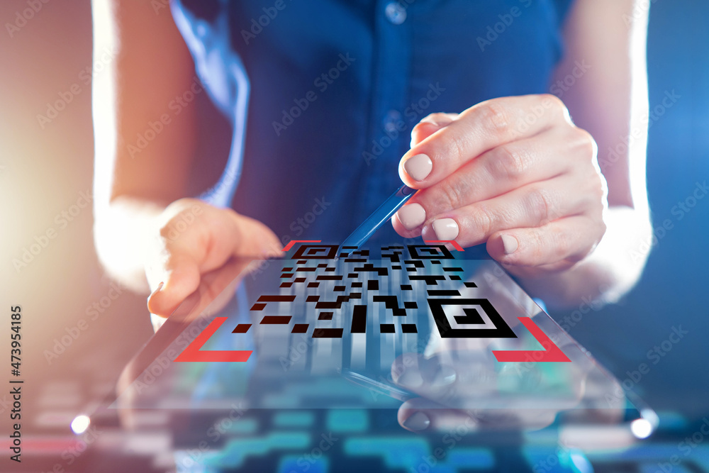 Checking qr codes. Woman checks QR code using an electronic tablet. Applications for checking codes. Verification of QRcodes. Quick Response code concept. Checking qr codes. Woman checks QR code using an electronic tablet. Applications for checking codes. Verification of QRcodes. Quick Response code concept.