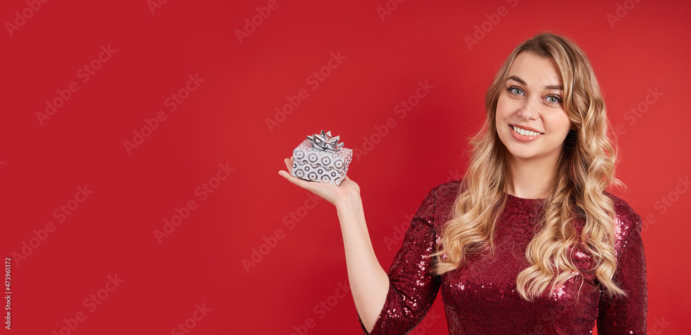 Adorable smiling blonde holding a gift box for Christmas, birthday, Valentine's day. Image with copy space Adorable smiling blonde holding a gift box for Christmas, birthday, Valentine's day. Image with copy space