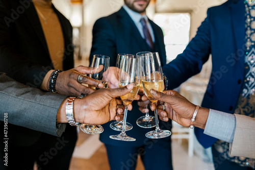 Hands of elegant men toasting champagne at banquet photo