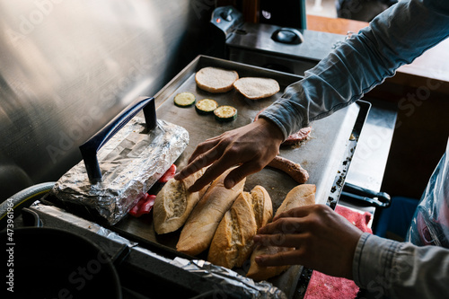 Chef grilling bread on griddle at restaurant