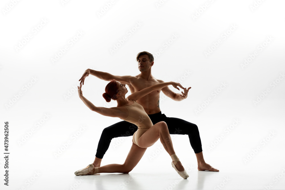 Elegant couple dancing ballet on white background