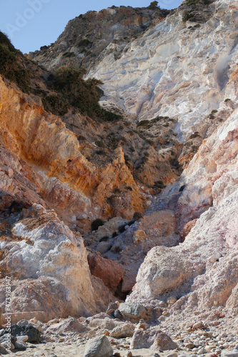 cliff of red and orange sulfur rocks on the wild Greek island of milos