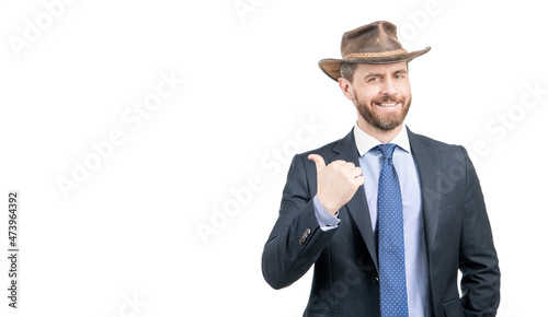 Happy businessman man in cowboy hat and suit smile pointing finger advertising gesture, advertise © Olena