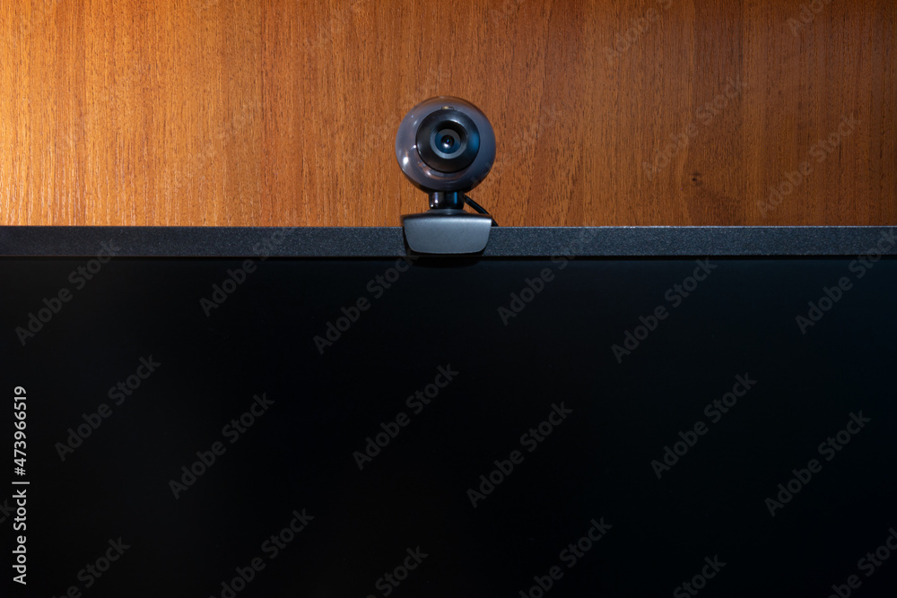 monitor. Webcam on a wooden background 