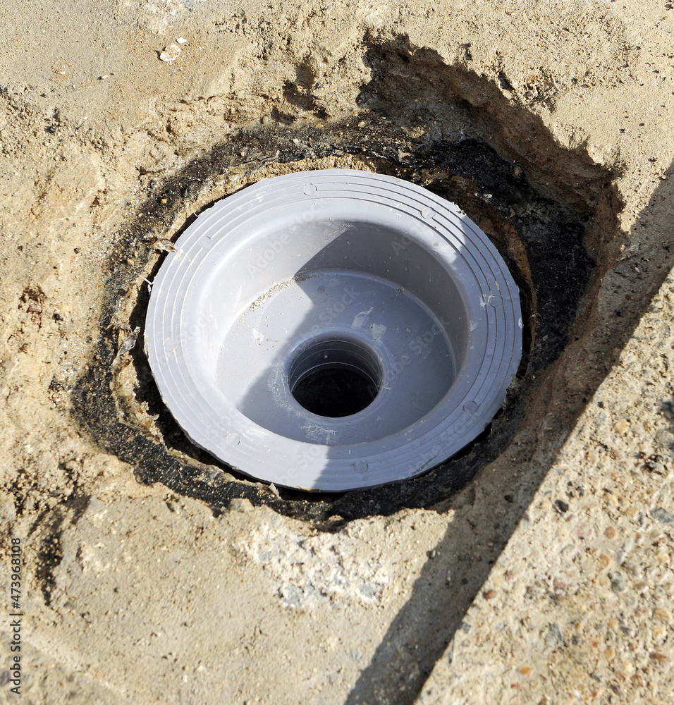 Bricklayer changing the plastic sump drain in the yard of a house because the water seepage Bricklayer changing the plastic sump drain in the yard of a house because the water seepage