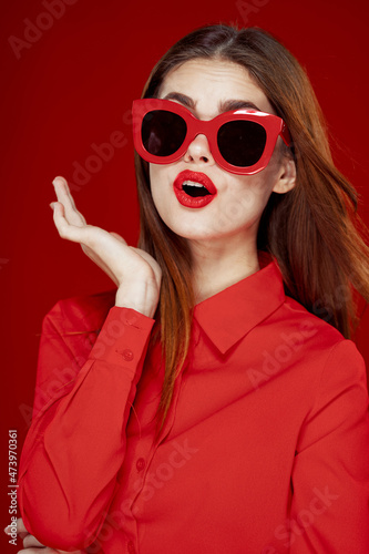 cheerful woman in a red shirt sunglasses Glamor close-up