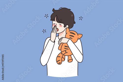 Tired small boy child with toy yawn feel fatigue want sleep. Exhausted small teen kid with teddy bear ready for bed in evening. Drowsiness and exhaustion. Childcare concept. Flat vector illustration. 