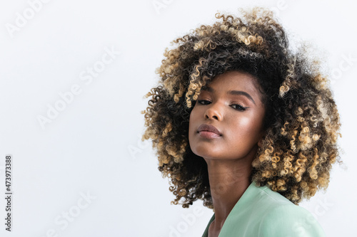 Young businesswoman with highlights hair in studio photo