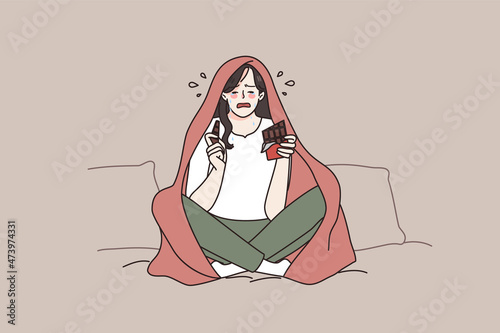Unhappy young woman sit on sofa in blanket cry after breakup eat chocolate. Upset lonely girl feel desperate broken at home, have guilty pleasure sweets. Female life problem. Vector illustration. 
