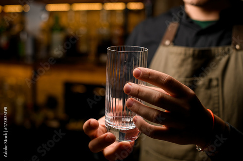 close-up shot of a male hand holding an empty drinking glass