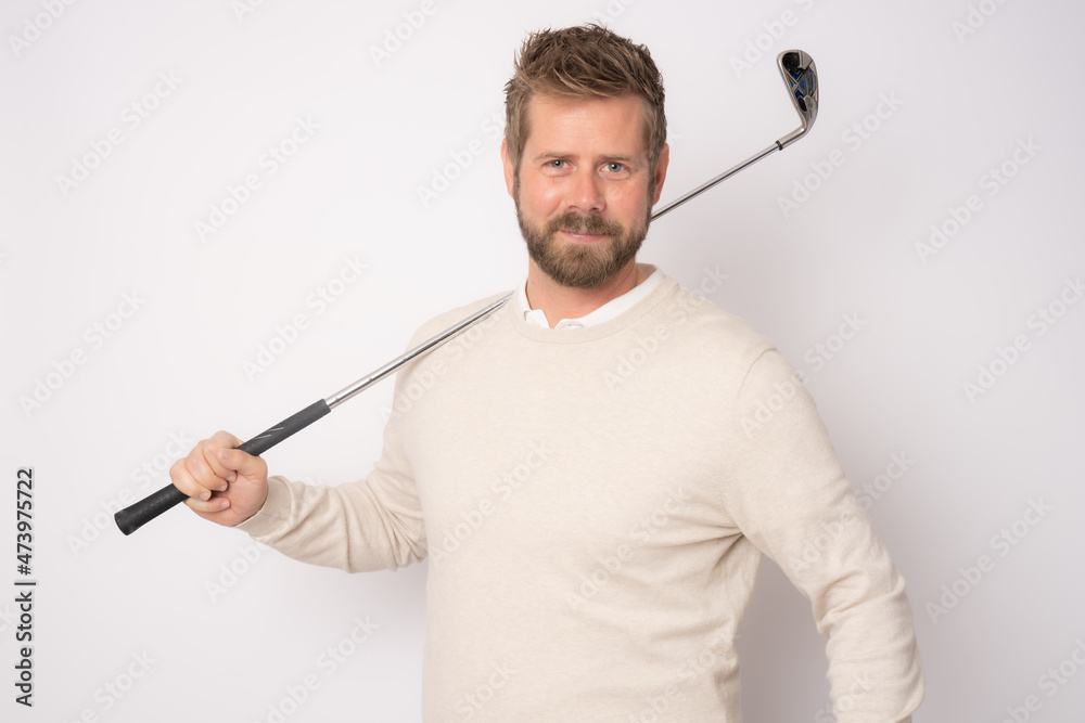 Young handsome man playing golf standing isolated over white background. Young handsome man playing golf standing isolated over white background.