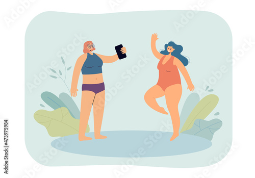 Female friends taking photos in swimming suits. Girl posing for woman holding phone flat vector illustration. Social media, traveling, summer concept for banner, website design or landing web page