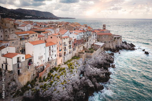 Evening landscape overlooking typical Sicilian houses by the sea in Cefalu, Italy. Tyrrhenian Sea at sunset