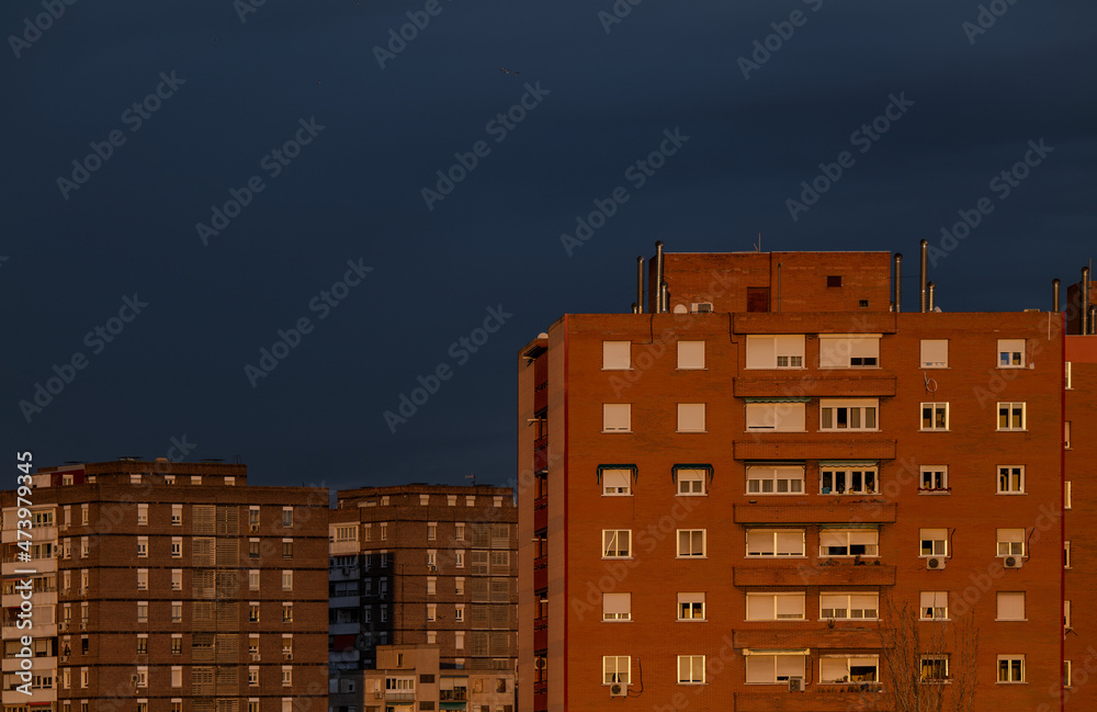 Residential buildings of Madrid, Spain, during sunset, against blue sky