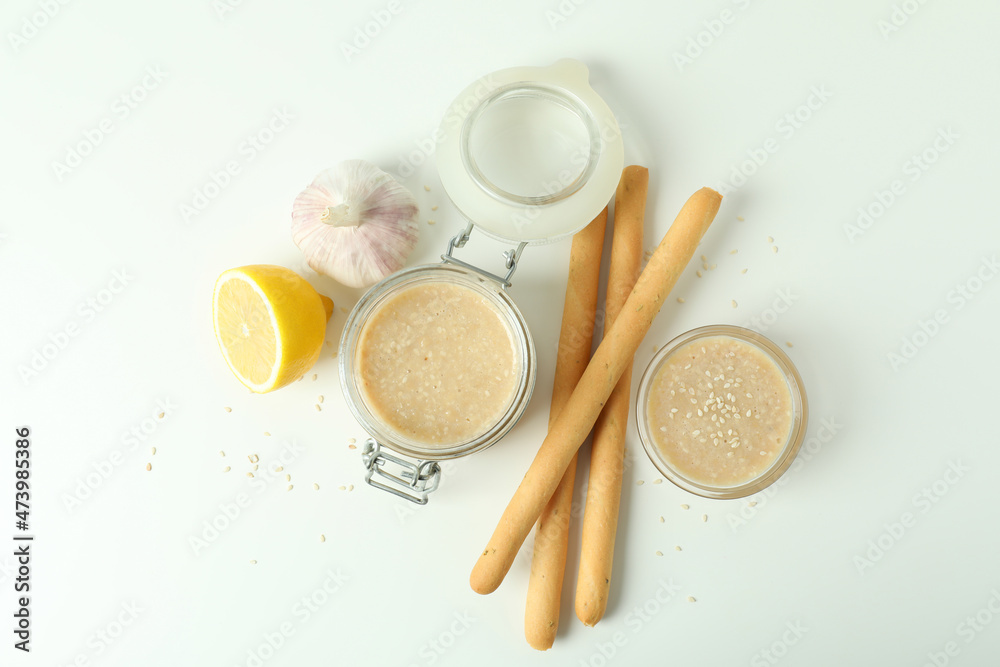 Concept of tasty food with tahini sauce on white background