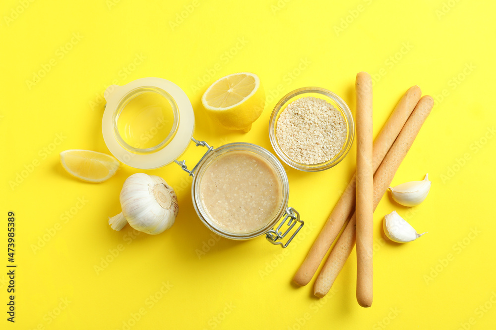 Concept of tasty food with tahini sauce on yellow background Concept of tasty food with tahini sauce on yellow background