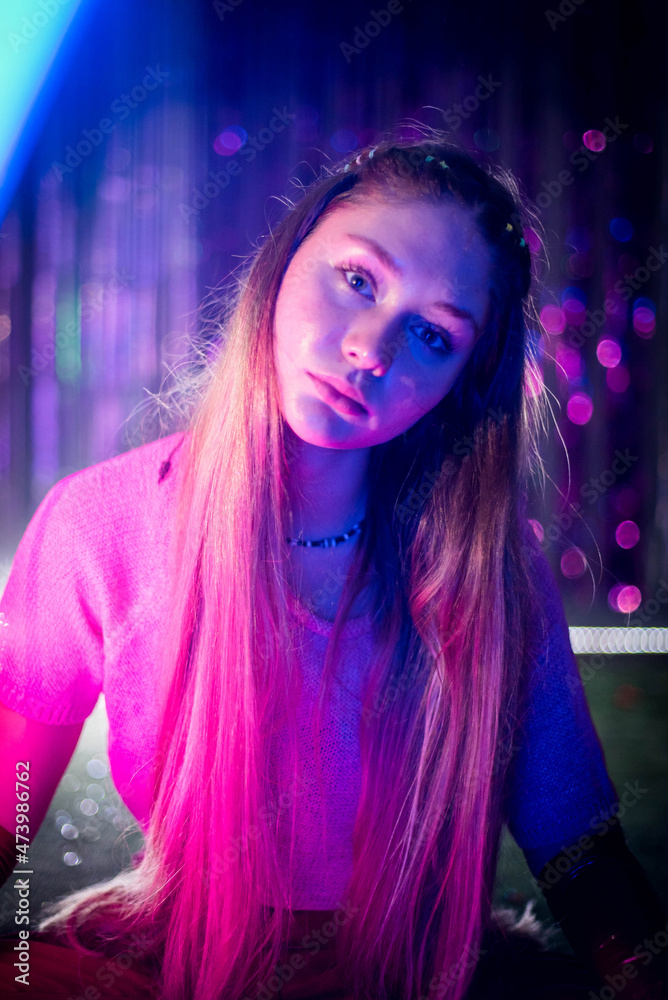 Fototapeta premium Cinematic night portrait of girl and neon lights. Fashion. Woman in Colorful neon light. girl in disco, makeup dance. Party disco neon nightclub vibes. creative art neon pink blue light.