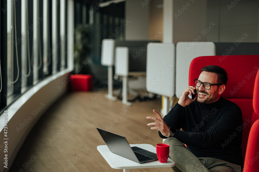 Laughing adult caucasian man, joking with his business partner, over the phone. Laughing adult caucasian man, joking with his business partner, over the phone.