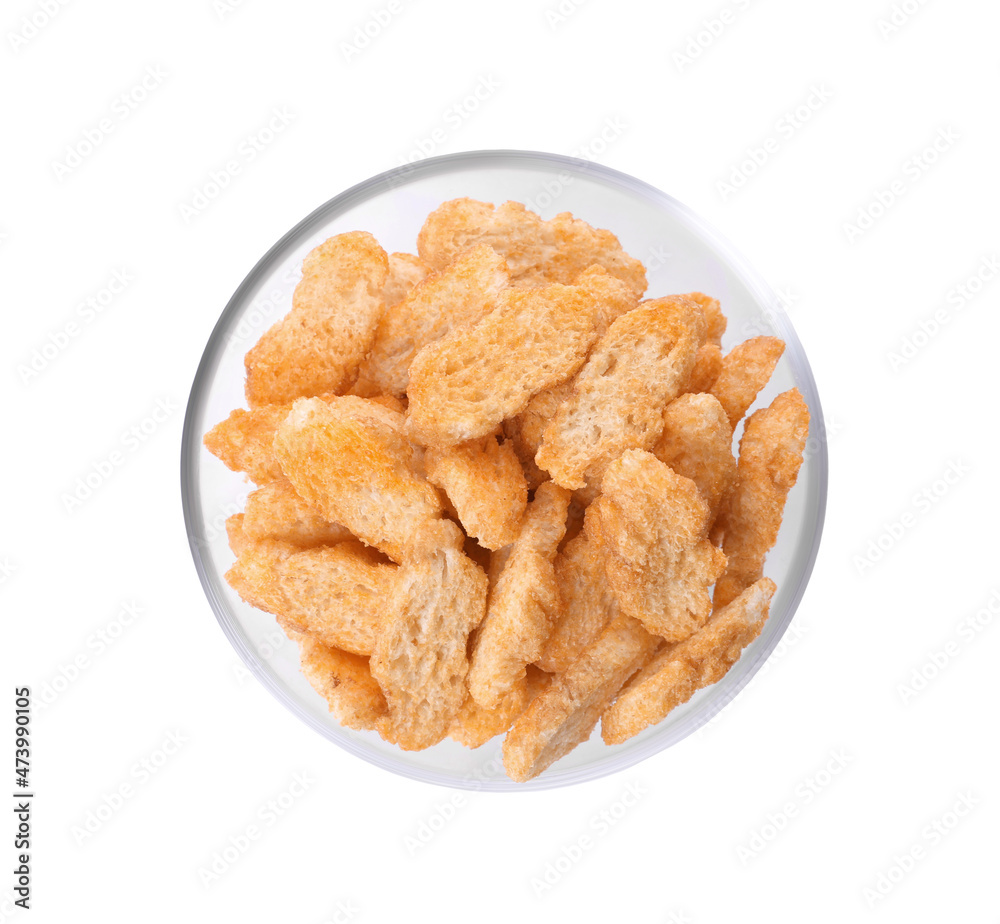 Crispy rusks with seasoning in bowl isolated on white, top view