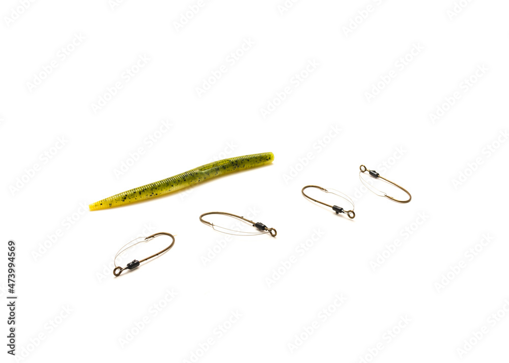 Multiple weedless bait holder hooks with single pumpkin plastic worm isolated on white Multiple weedless bait holder hooks with single pumpkin plastic worm isolated on white