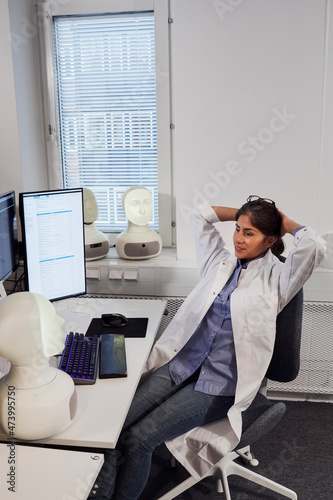Female engineer sitting at work station