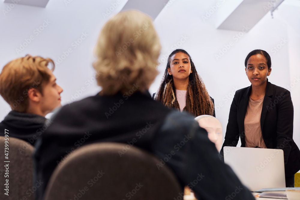 Business people discussing robot voice assistant during meeting Business people discussing robot voice assistant during meeting