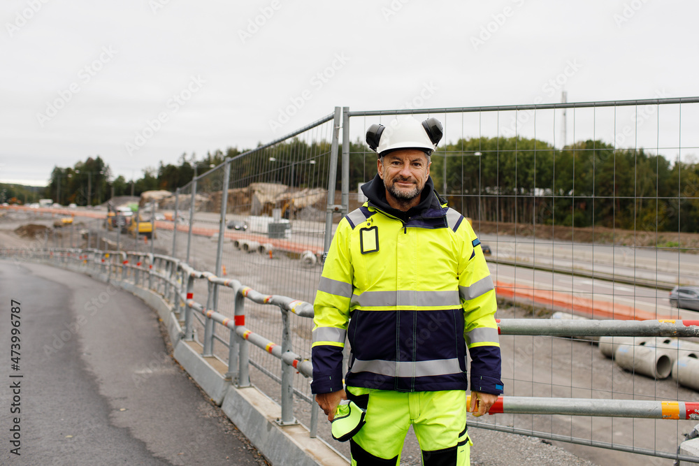 Portrait of male engineer in reflecting clothing at building site Portrait of male engineer in reflecting clothing at building site