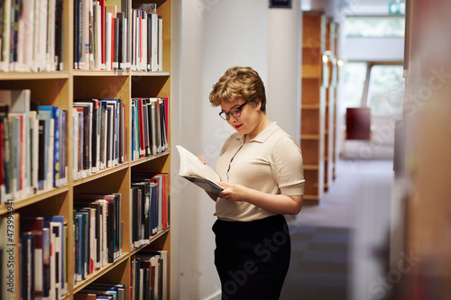 Young female student in library photo