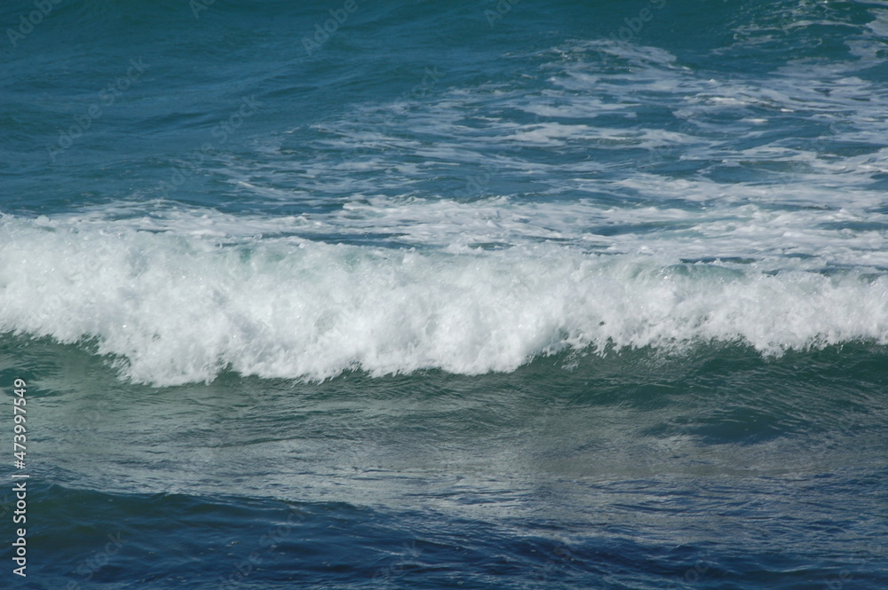 A stormy surface with waves of the sea and bubbles