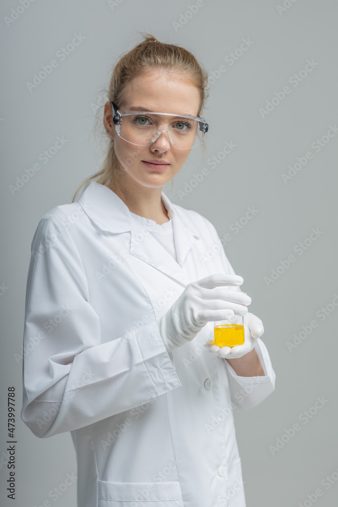 Chemical test tubes and flasks with petroleum products, the girl is a laboratory assistant, safety glasses Chemical test tubes and flasks with petroleum products, the girl is a laboratory assistant, safety glasses