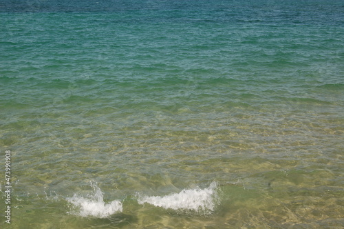 A stormy surface with waves of the sea and bubbles