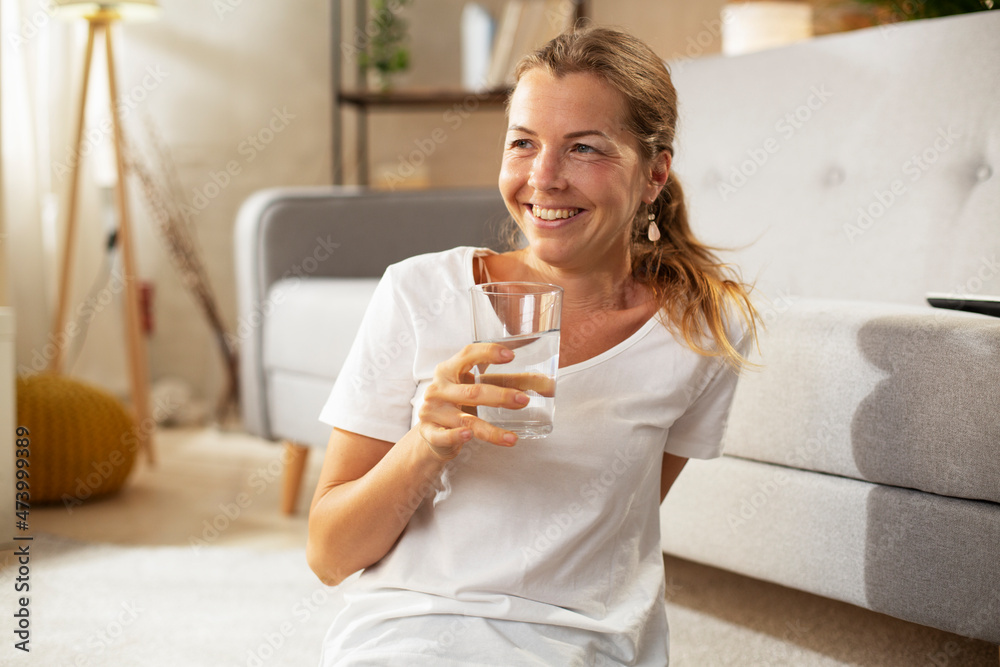 Girl holding a glass of water. Smiling girl drinking water Girl holding a glass of water. Smiling girl drinking water