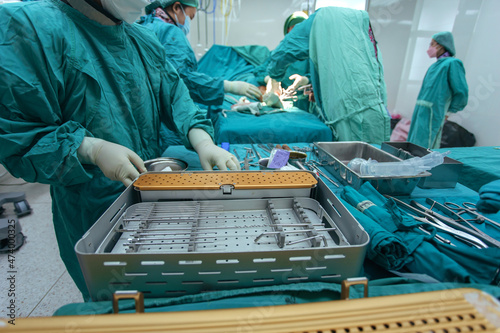 Selective focus, Assistant Orthopedic doctor preparing instruments for operation bone fracture on the table.