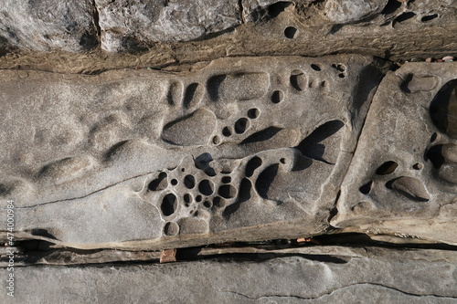 texture of porous stones on the beach, nature, natural phenomena, brown-gray stones photo