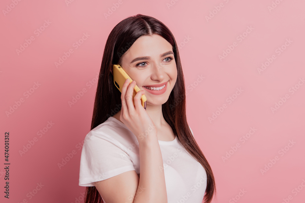 Photo of young beautiful lovely smiling positive girl talk cellphone conversation isolated on pink color background Photo of young beautiful lovely smiling positive girl talk cellphone conversation isolated on pink color background