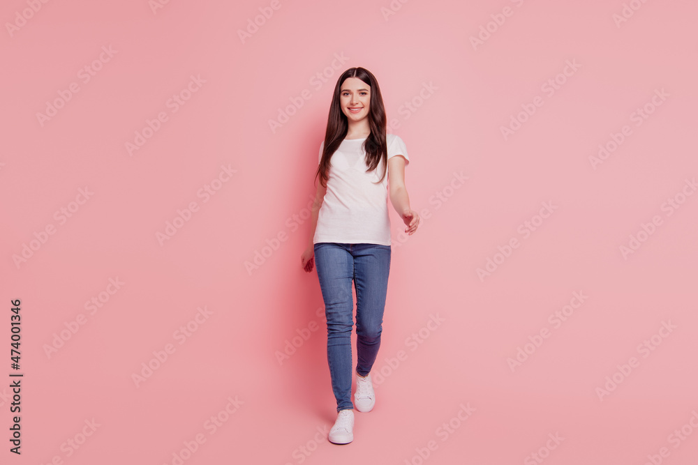 Full body photo of cheerful girl happy smile go walk step wear casual style outfit isolated over pink color background Full body photo of cheerful girl happy smile go walk step wear casual style outfit isolated over pink color background