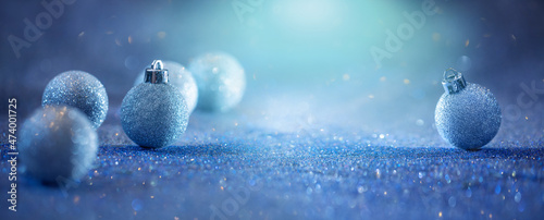 glitter baubles on a blue glitter background, background for Christmas photo