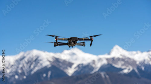 Fototapeta Naklejka Na Ścianę i Meble -  Drone hovering on the background of snow capped mountains. Sochi, Russia.