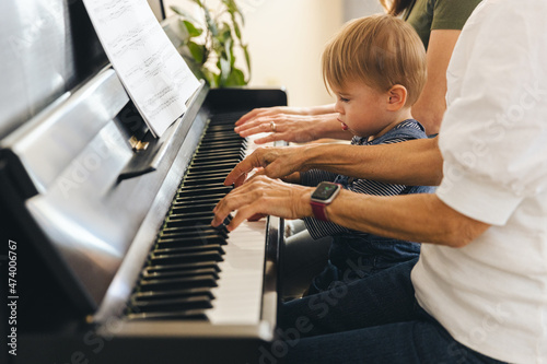 Multi Generation Family Learning Piano At Home