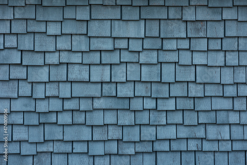 Photography Abstract painted uneven rows of blue wooden house shingles.
