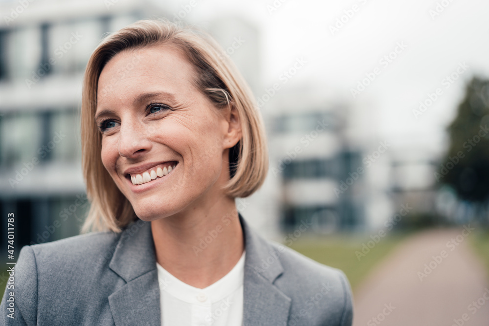 Female entrepreneur smiling while looking away Female entrepreneur smiling while looking away