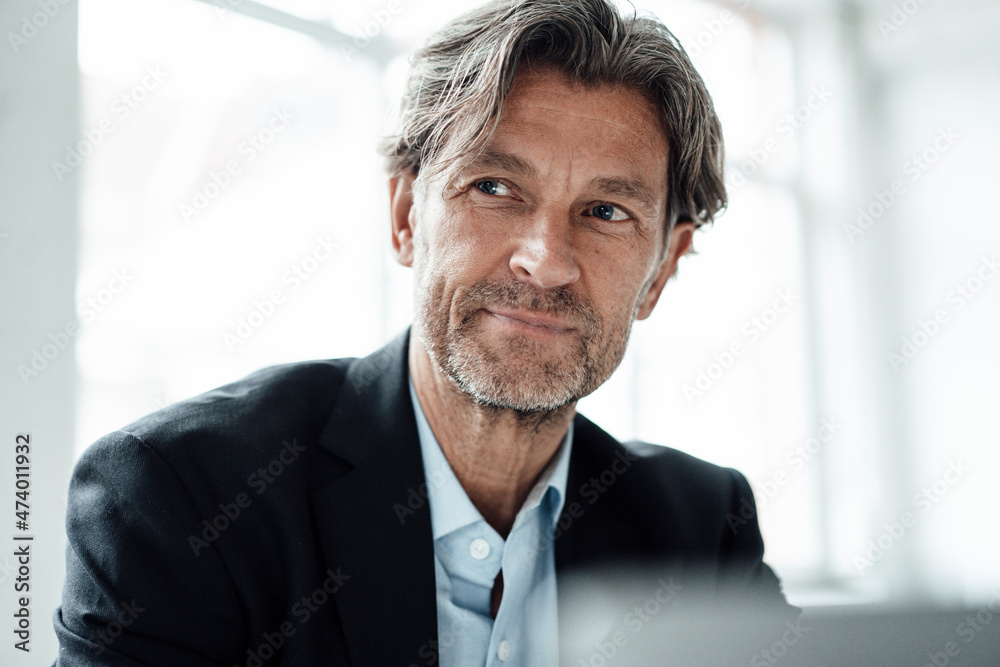 Mature businessman with gray hair and stubble looking away Mature businessman with gray hair and stubble looking away