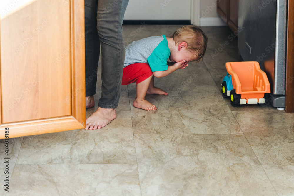 Boy Crying While Crouching By Toy At Home Boy Crying While Crouching By Toy At Home