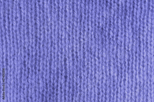 Trendy Color of Year Very peri. texture of knitted angora fabric. Violet wool texture. Knitted jersey background with relief pattern for wallpaper and abstract background. Wool hand- machine, handmade